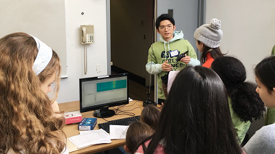 Tingjun demonstrating the principles of wireless communications using a walkie-talkie at the Columbia Girls’ Science Day